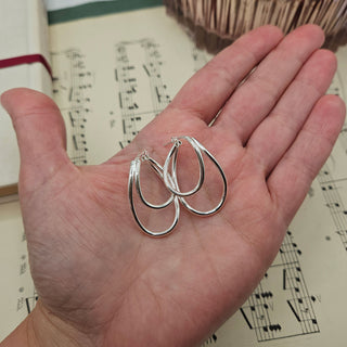 earrings in hand for scale