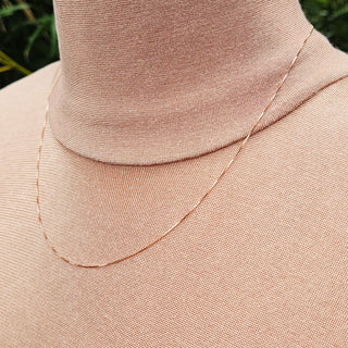 fine 9ct rose gold box chain being worn