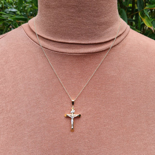 gold inri crucifix being worn