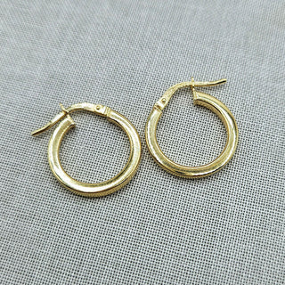 close of of small yellow gold hoops