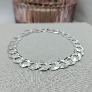 close up of flat links on silver curb bracelet