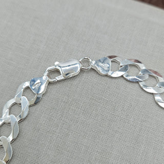 lobster clasp on men's silver curb bracelet