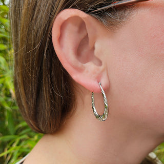 silver gypsy creoles in ladies ear