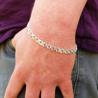 silver double curb bracelet on man's wrist