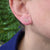 olive branch earrings being worn