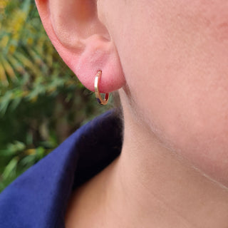 dainty gold hoops in ear