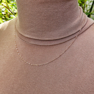 dainty rose gold chain pictured on neck