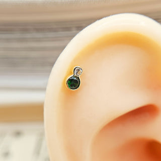 dainty solid gold helix earring with green gemstone