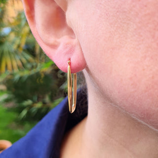 rectangular creole earring being worn