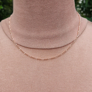 solid rose gold figaro necklace being worn