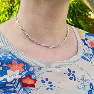 silver paperclip chain on ladies neck