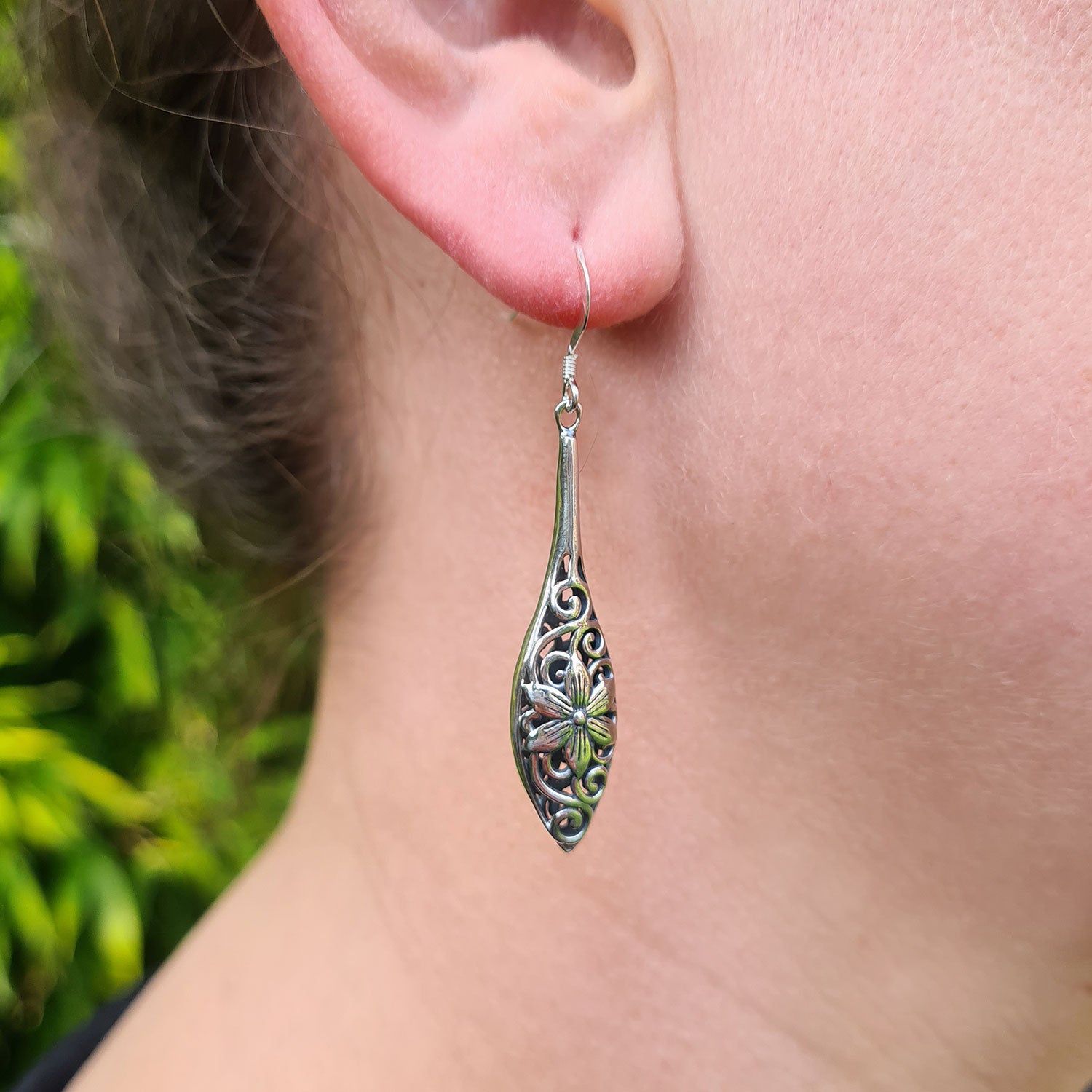 solid sterling silver drop earrings being worn in ladies ear