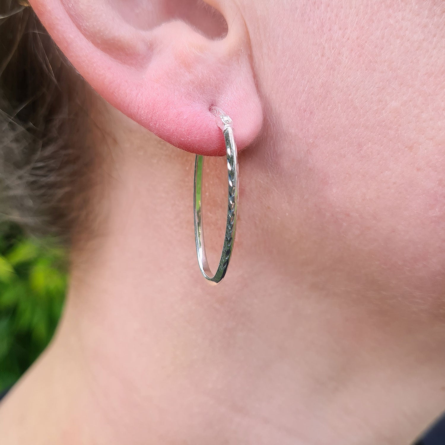 oval hoop earrings in ladies ear