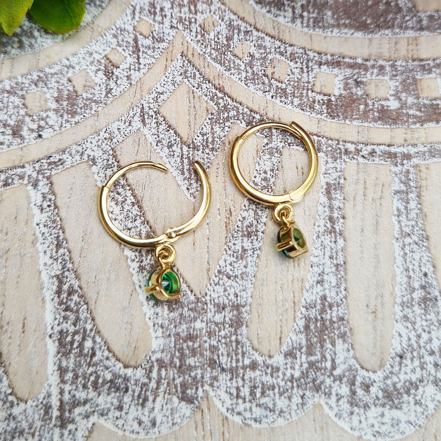 side profile of solid gold huggie earrings