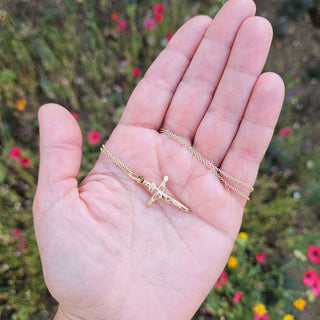 crucifix in hand for scale