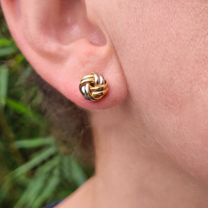 yellow white gold knot earrings in ladies ear