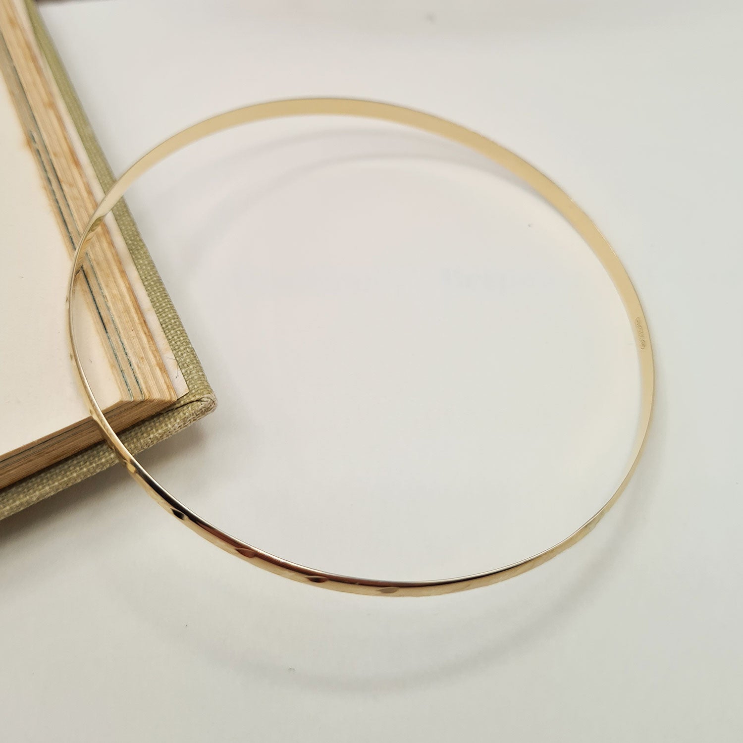 women's gold bangle made from D-shaped wire