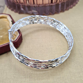 group of silver stacking bangles