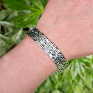 women's silver bangle on wrist