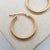 close up of yellow gold hoop earrings