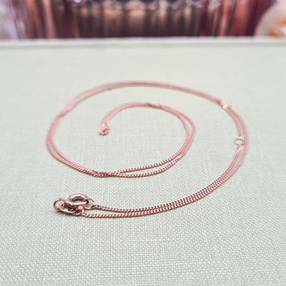 close up or rose gold pendant chain