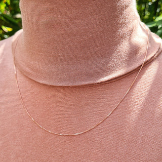 image of fine rose gold pendant chain on neck