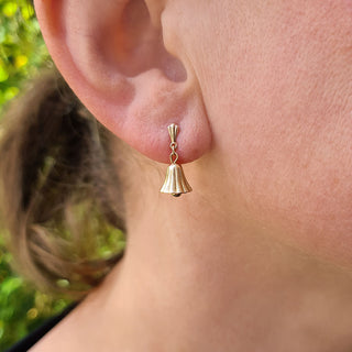 bell shaped drop earrings in woman's ear