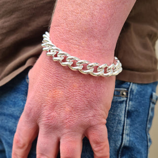 heavy curb chain bracelet on man's wrist