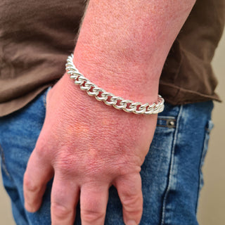 men's curb bracelet in silver shown on the wrist