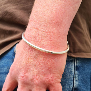 silver bangle on man's wrist