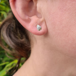 dainty teardrop studs in woman's ear