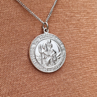 close up of white gold st christopher