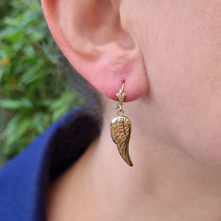 women wearing angel wing earrings