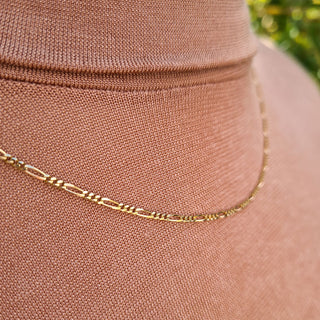 close up of figaro links on gold chain