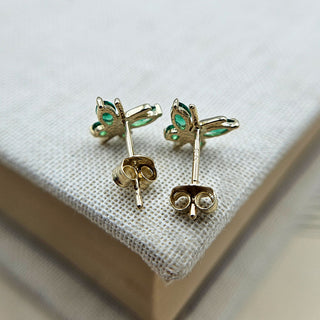 backs of butterfly stud earrings in gold