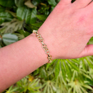 gold celtic bracelet on ladies wrist