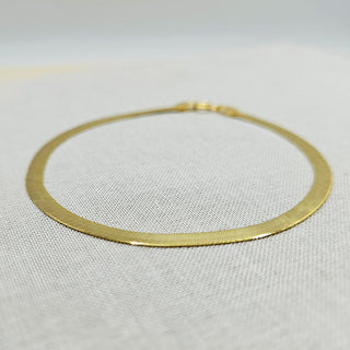 flat gold bracelet with herringbone design