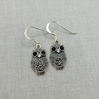 own dangle earrings decorated with marcasite stones