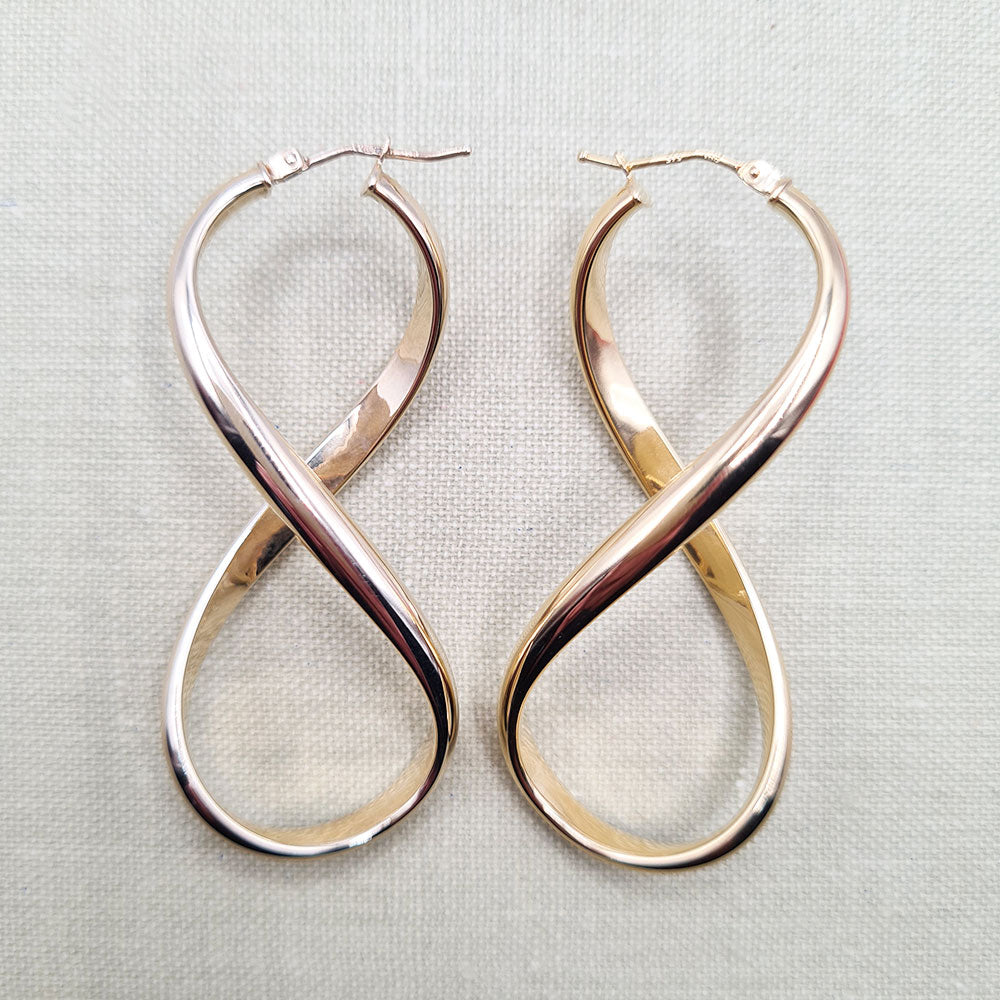 real gold figure 8 statement earrings