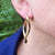 statement gold earrings in ear