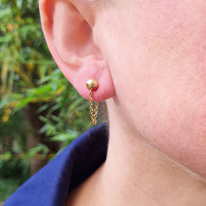 chain drop earrings in ear