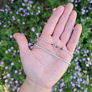 silver rope chain in hand for scale