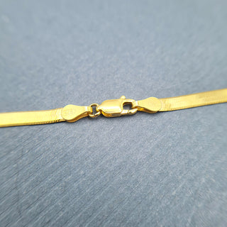 close up of clasp on flat gold snake chain