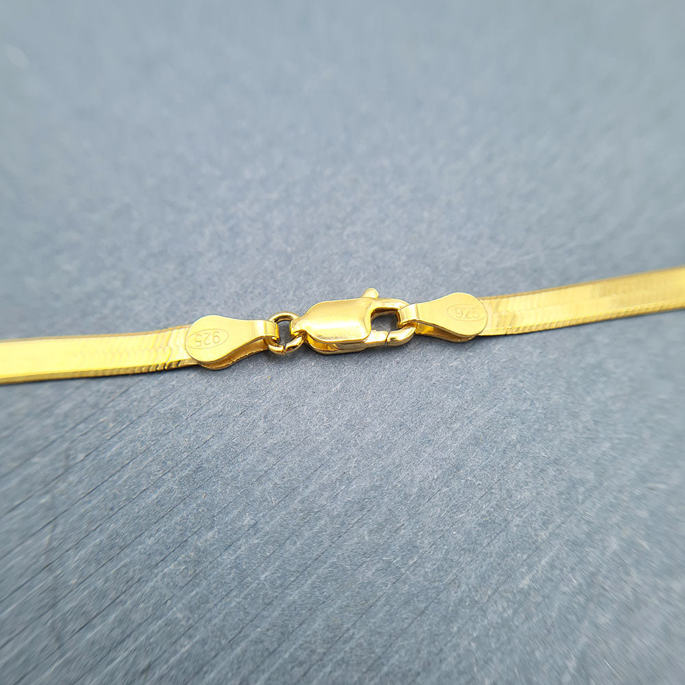 close up of clasp on flat gold snake chain