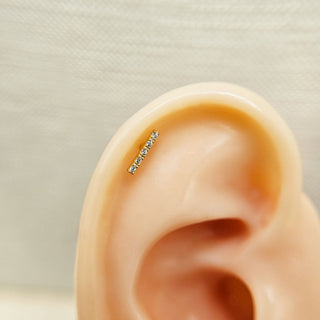 bar earring with cz in cartilage of ear