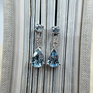 close up of aquamarine and diamond earrings