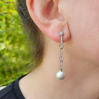 long drop pearl earrings in ladies ear