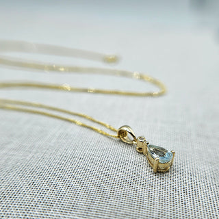 pear shaped aquamarine and tiny diamond set in 9ct gold pendant