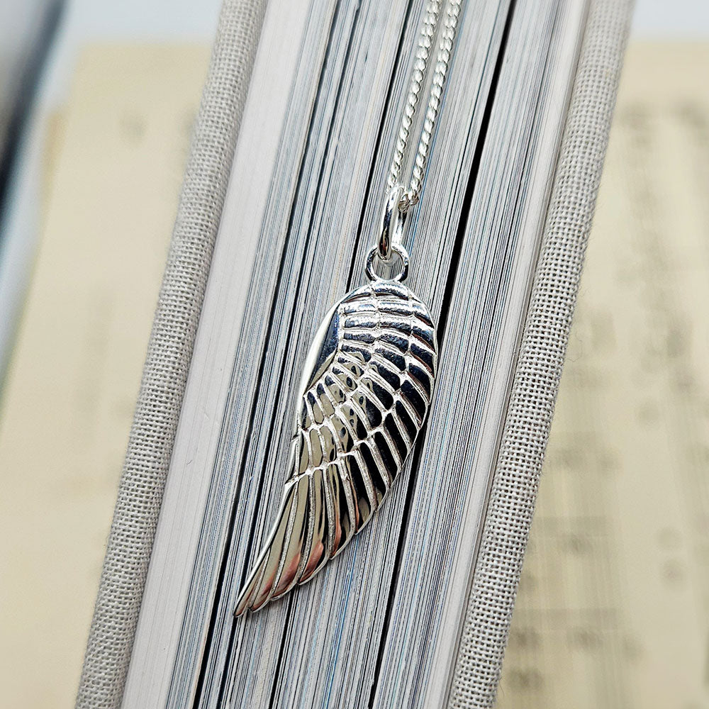 1/10 CT. T.W. Diamond Single Angel Wing Pendant in Sterling Silver with 1/10 CT. T.W. Diamond Single Angel Wing Pendant in Sterling Silver with