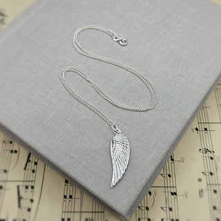 angel wing pendant on good quality silver curb chain